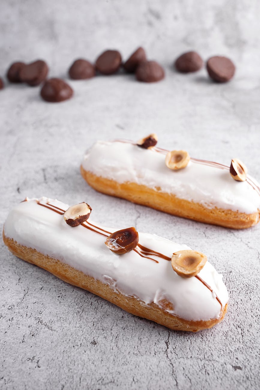 tasty fresh eclairs on marble table